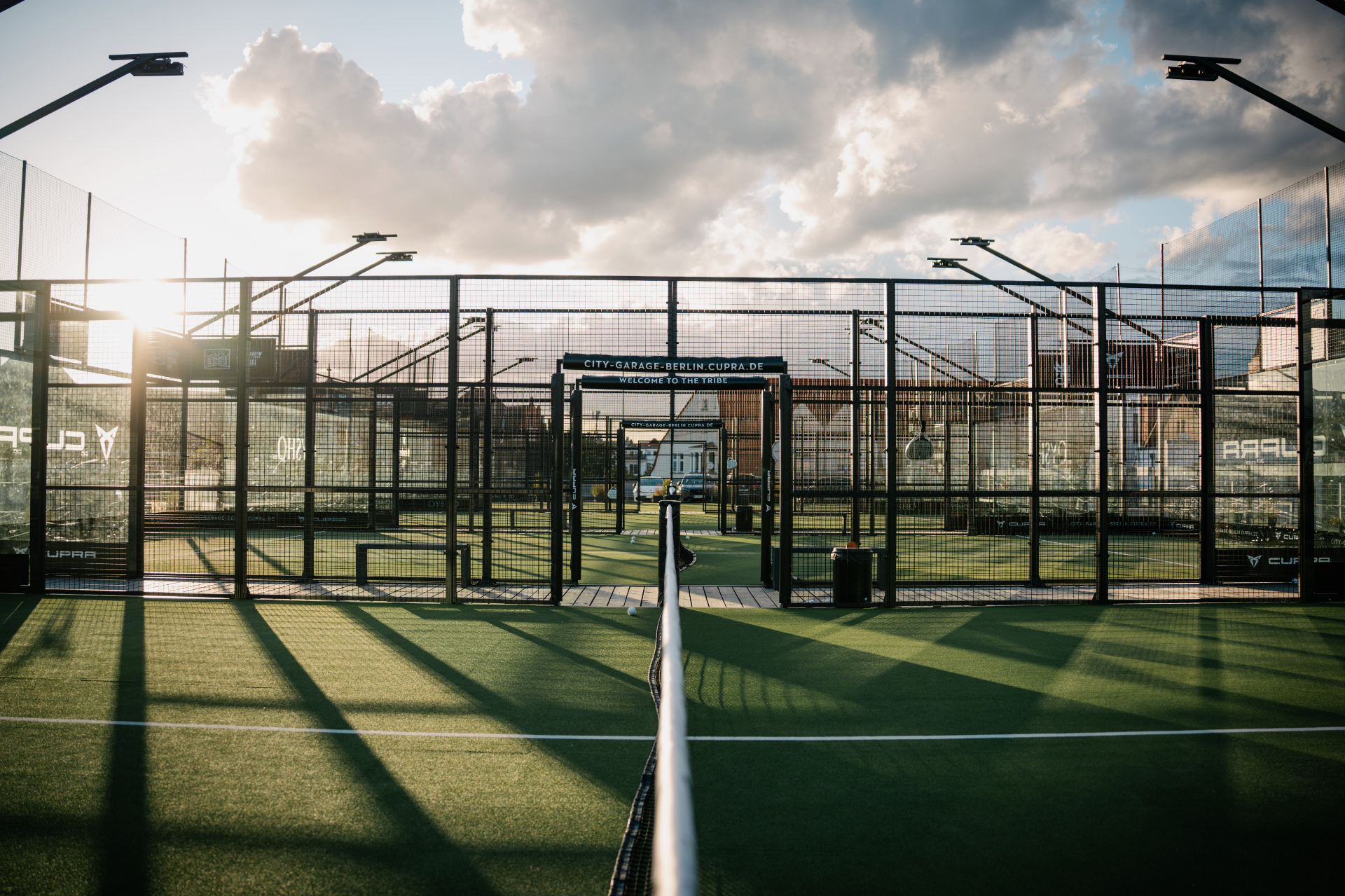 Players on a Berlin padel court at dusk
